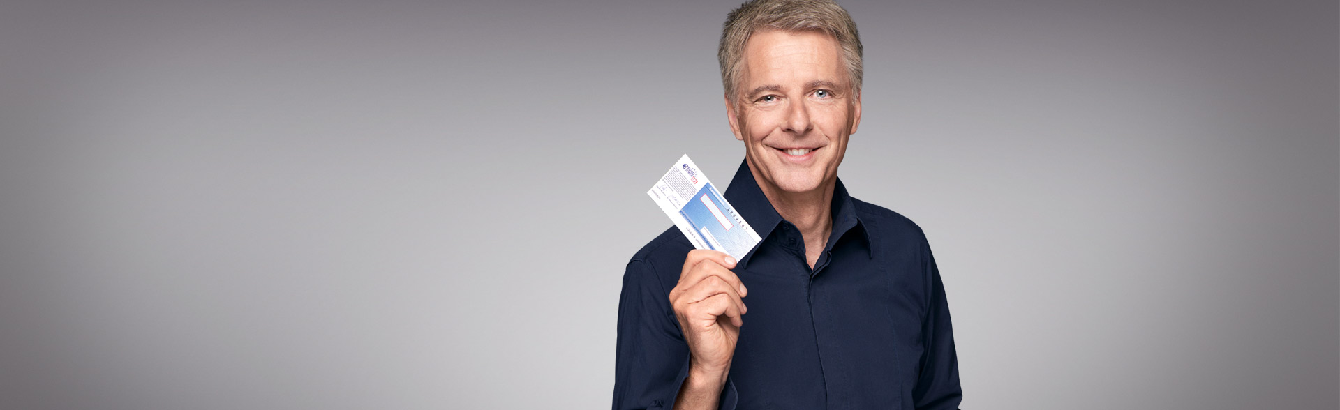 Jörg Pilawa hält ein Los in der Hand
